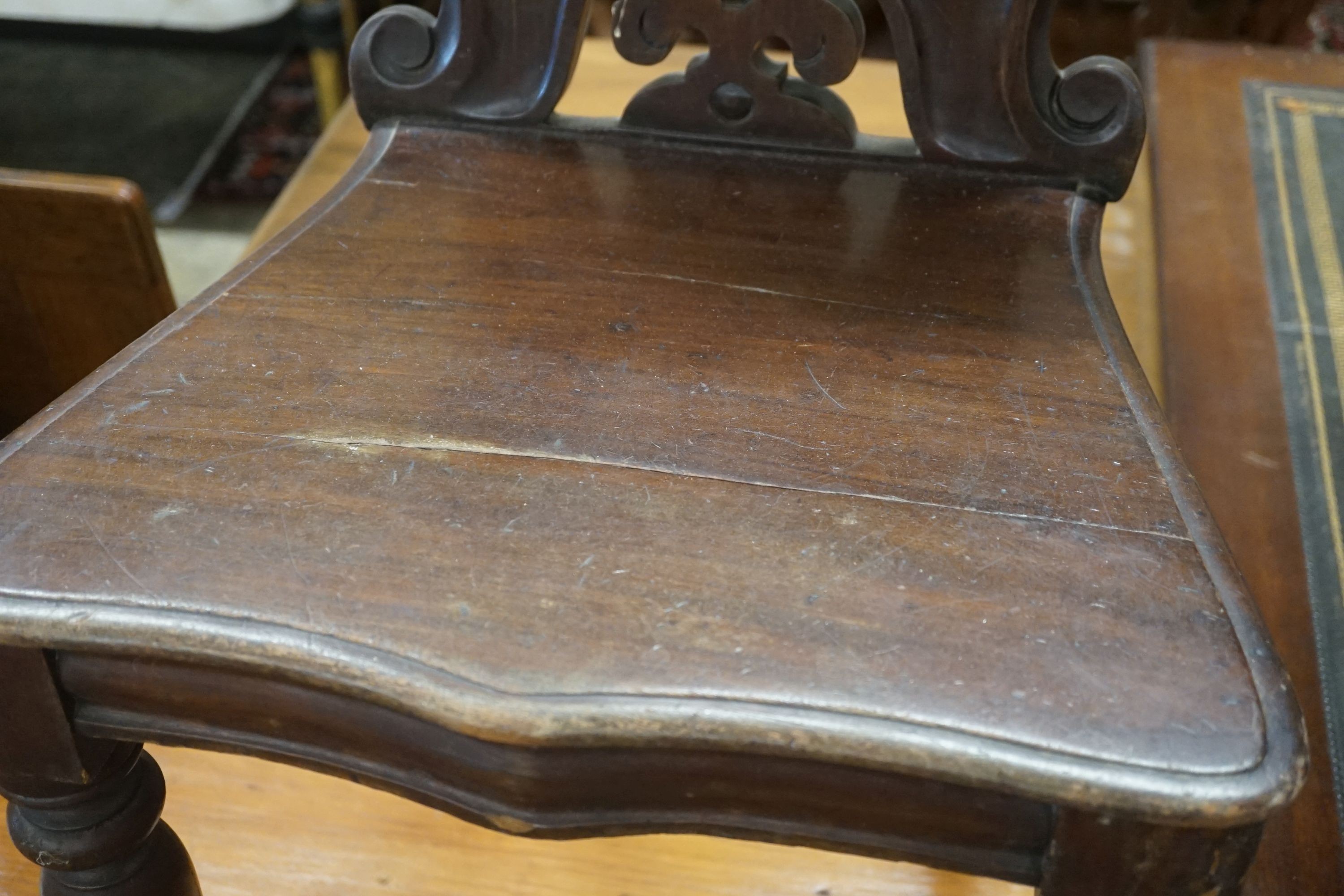 A pair of Victorian mahogany hall chairs